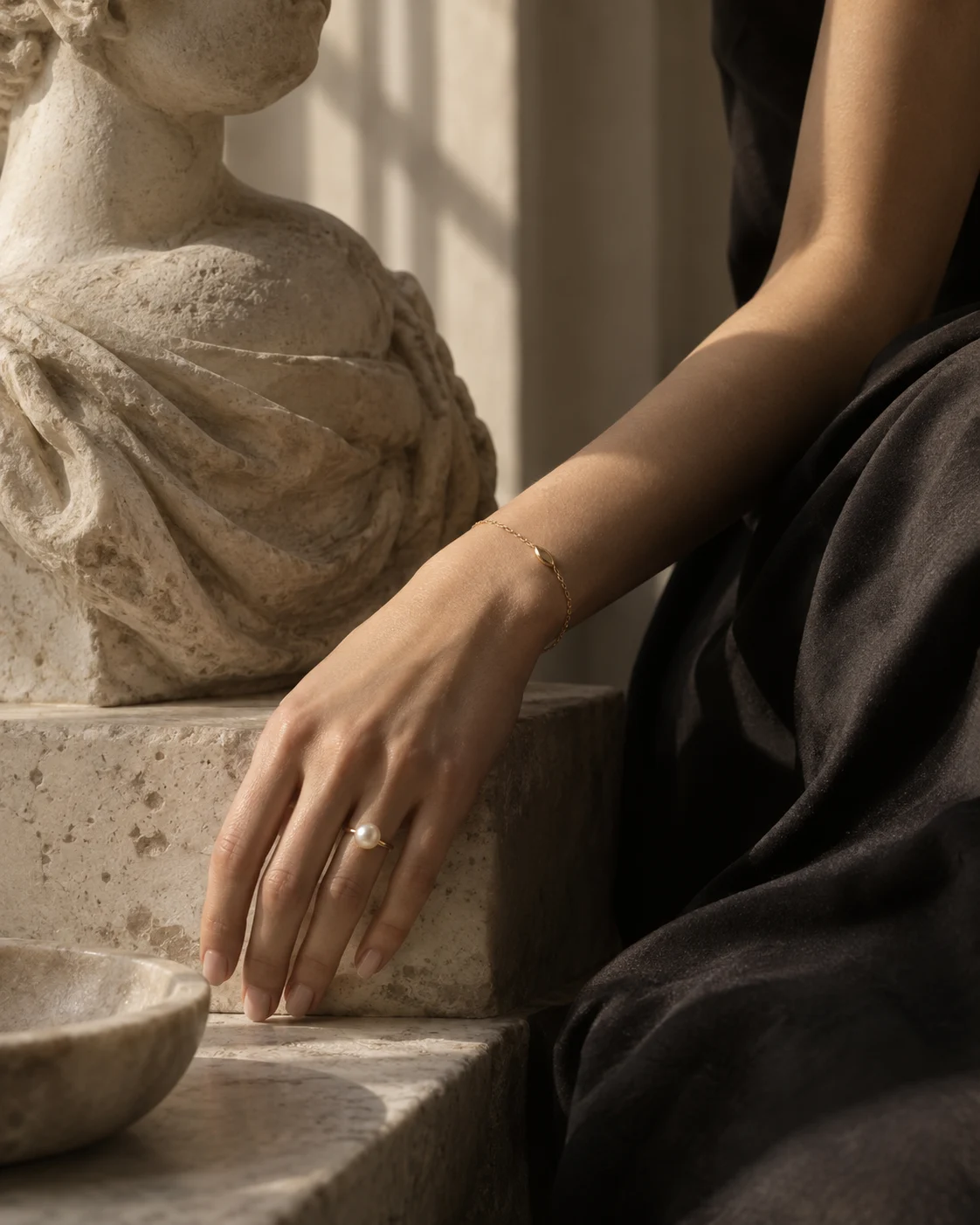 ANGEL MYTH jewelry worn beside a limestone sculpture